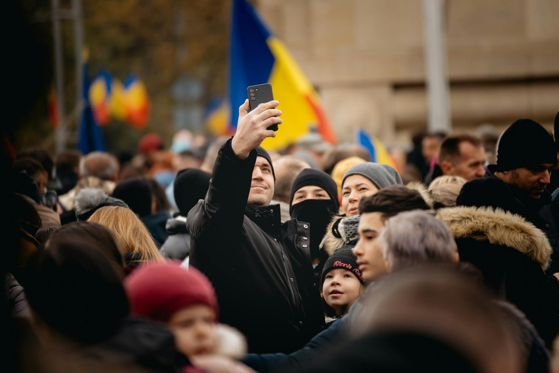man with smartphone in crowd